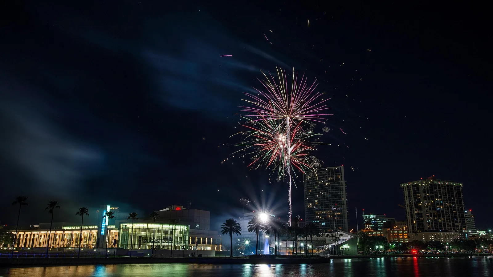 Fireworks over the downtown St. Petersburg waterfront by Al Lang Stadium, with the Mahaffey Theater at left.