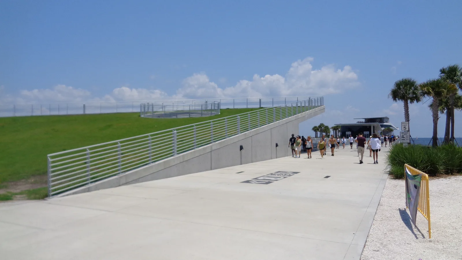 Visitors walk the length of the St. Pete Pier toward the Pier Head building on a summer afternoon.