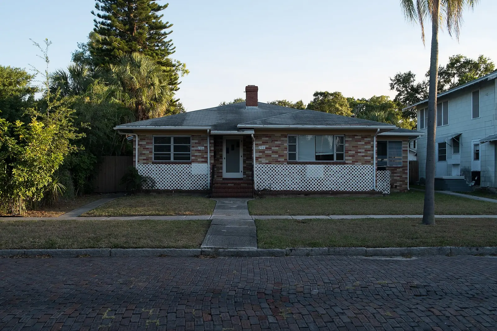 A brick duplex on a brick-paved street in the Historic Old Northeast neighborhood of St. Petersburg.