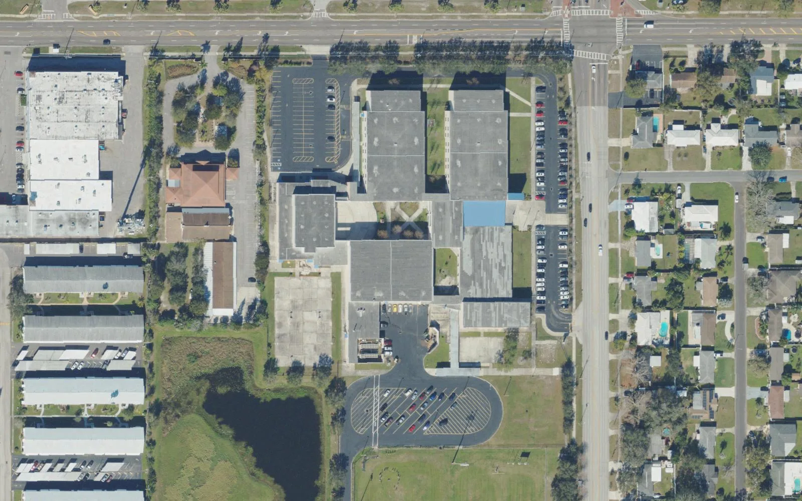 Meadowlawn Middle School's campus on 16th Street North in St. Petersburg seen from the air, with a retention pond south of the buildings.