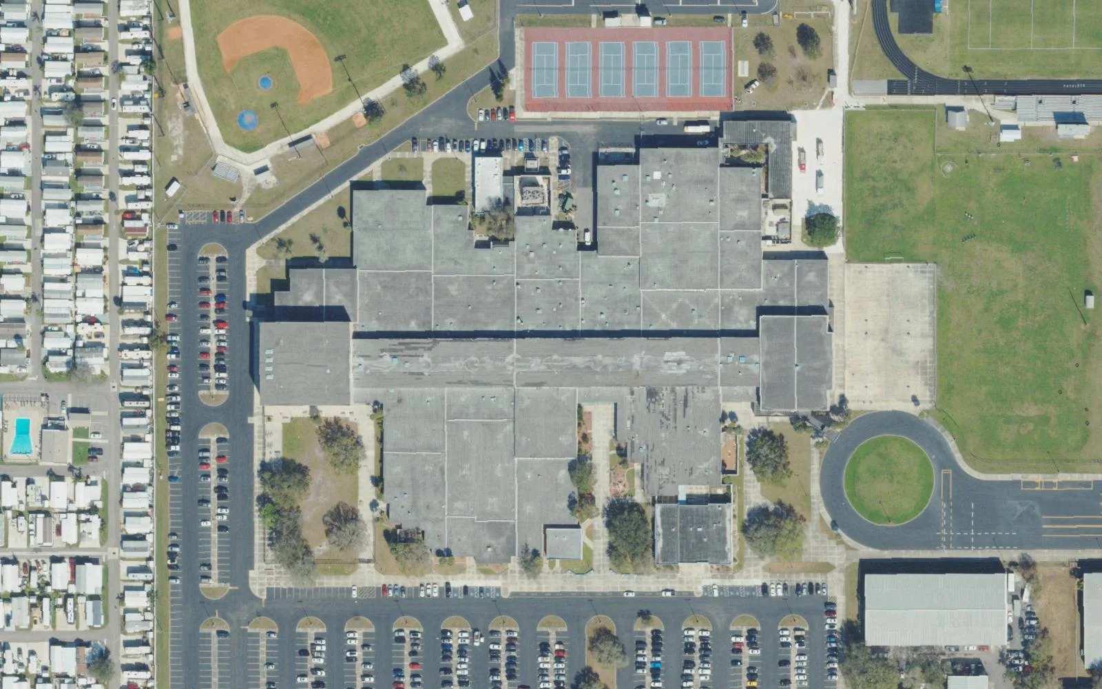 Pinellas Park High School's campus on 118th Avenue seen from the air, with its tennis courts and baseball field at the top.