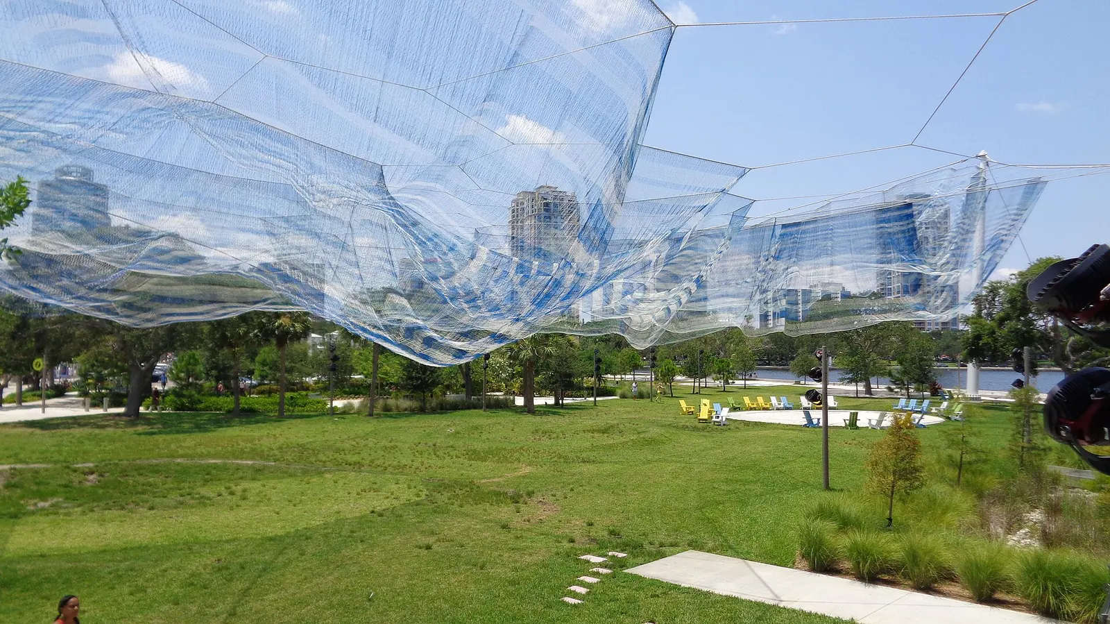 The Bending Arc net sculpture over the lawn at the land end of the St. Pete Pier.
